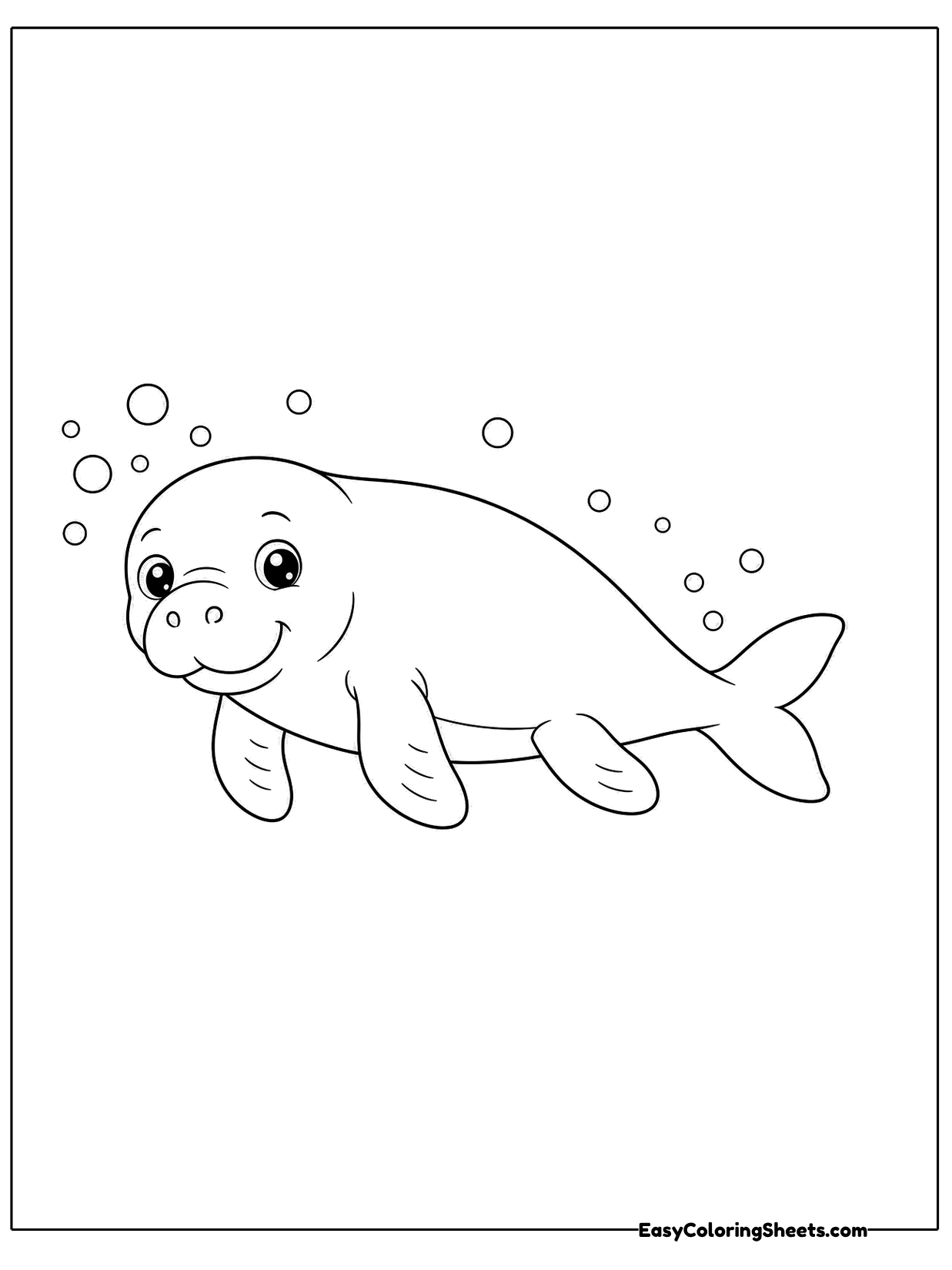 A manatee swims to the right with a trail of bubbles drifting above it.