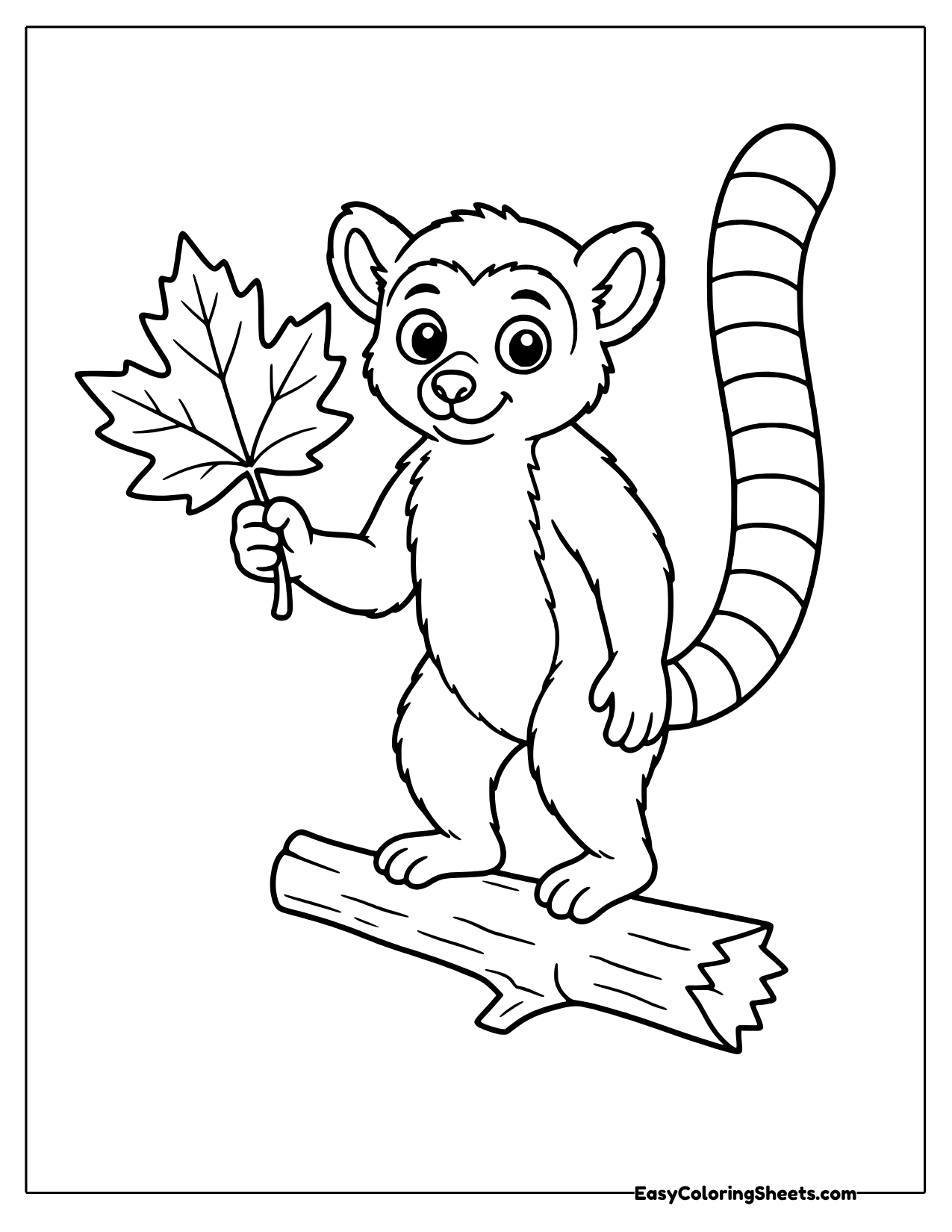 Lemur holding a maple leaf on a log