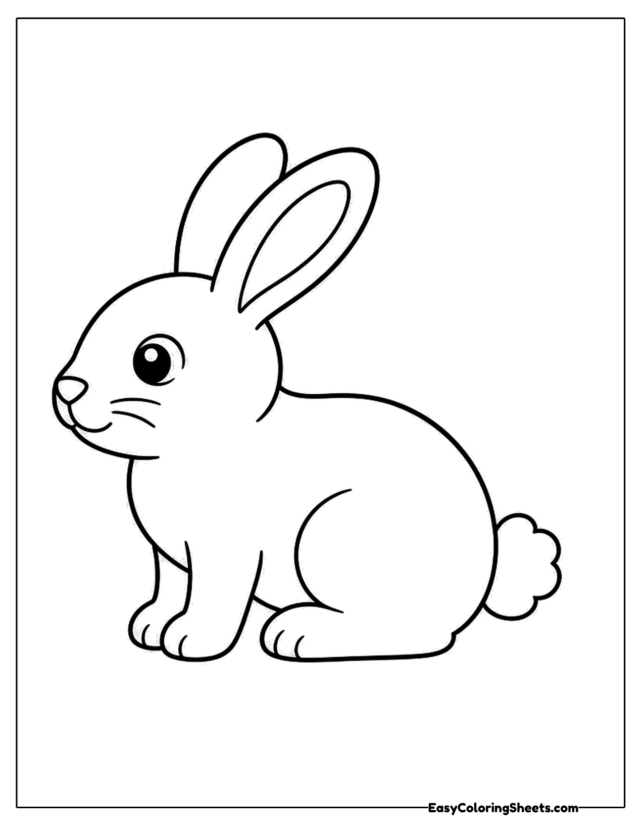 Side view of a cottontail rabbit sitting with a round fluffy tail