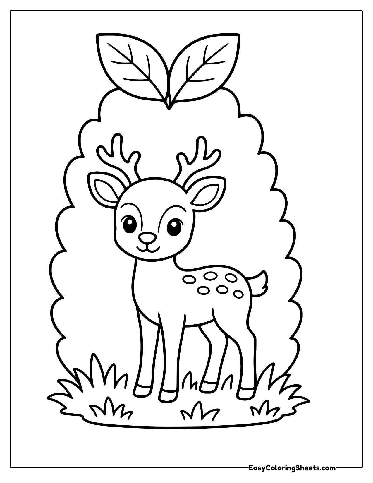 Fawn nestled in a leafy bush