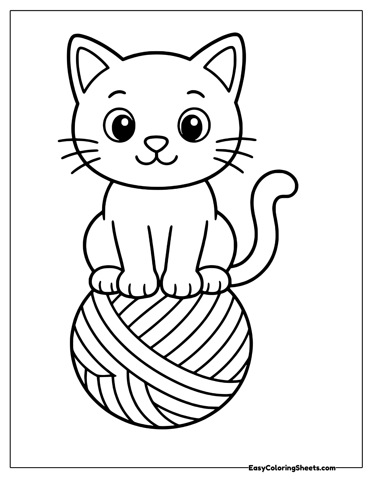 Kitten sitting on top of a ball of yarn