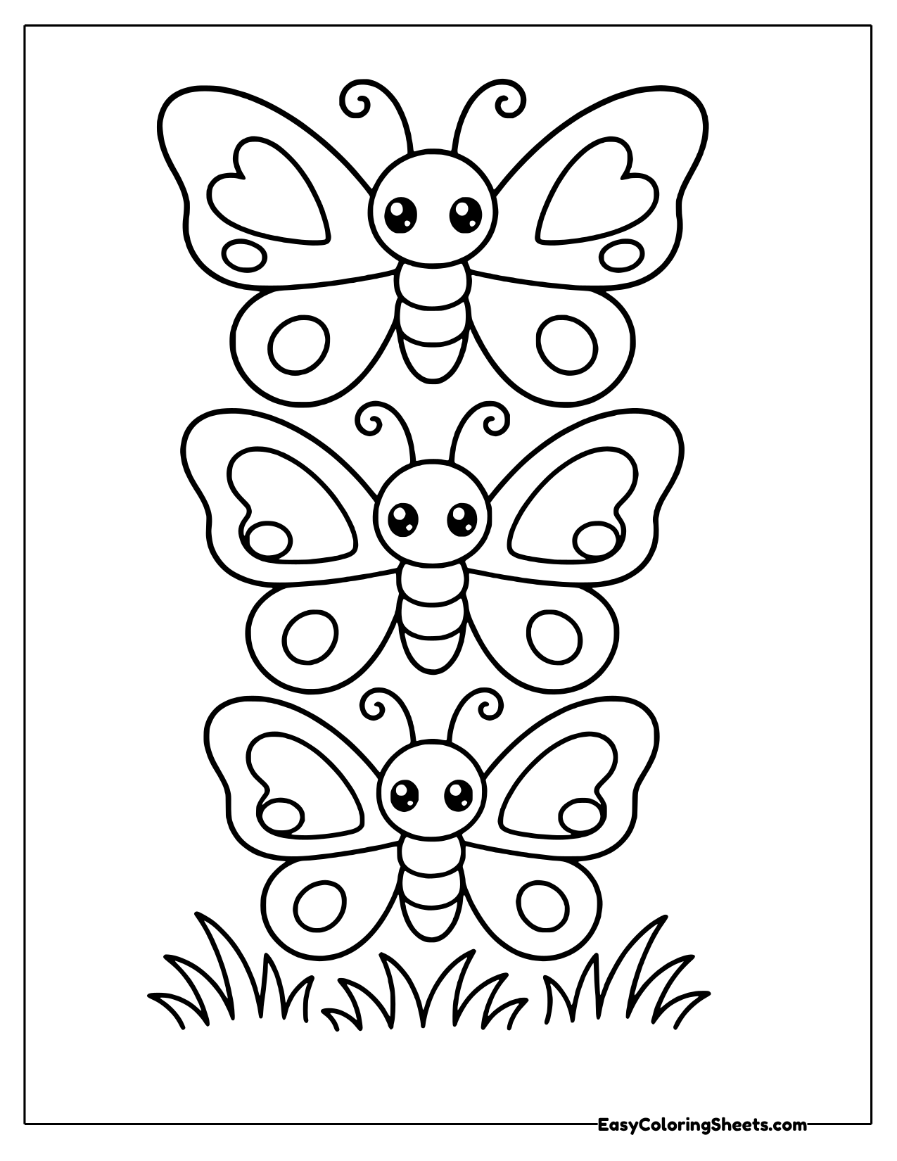 Three butterflies stack in a neat tower over a row of grass, each with heart shapes on its wings.