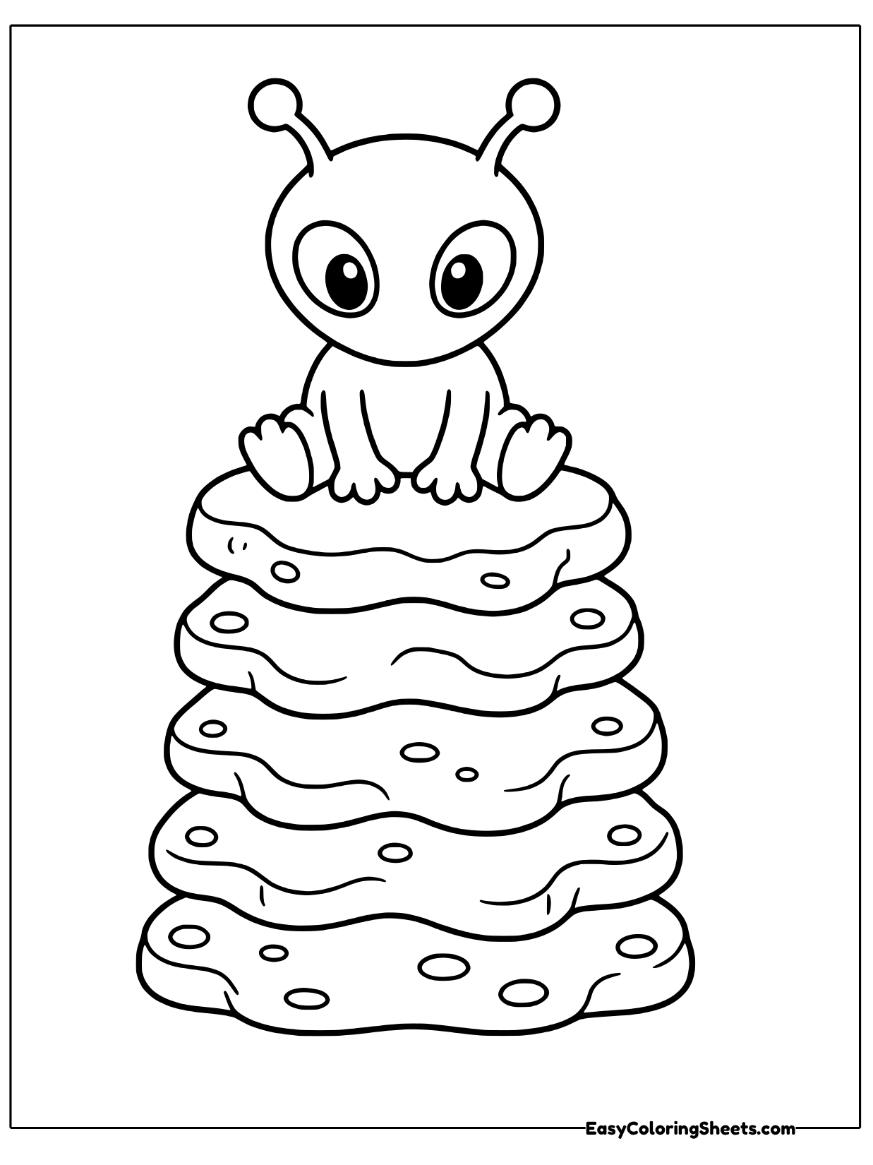 A smiling alien sits on top of a tall tower of rounded, wavy rock layers.