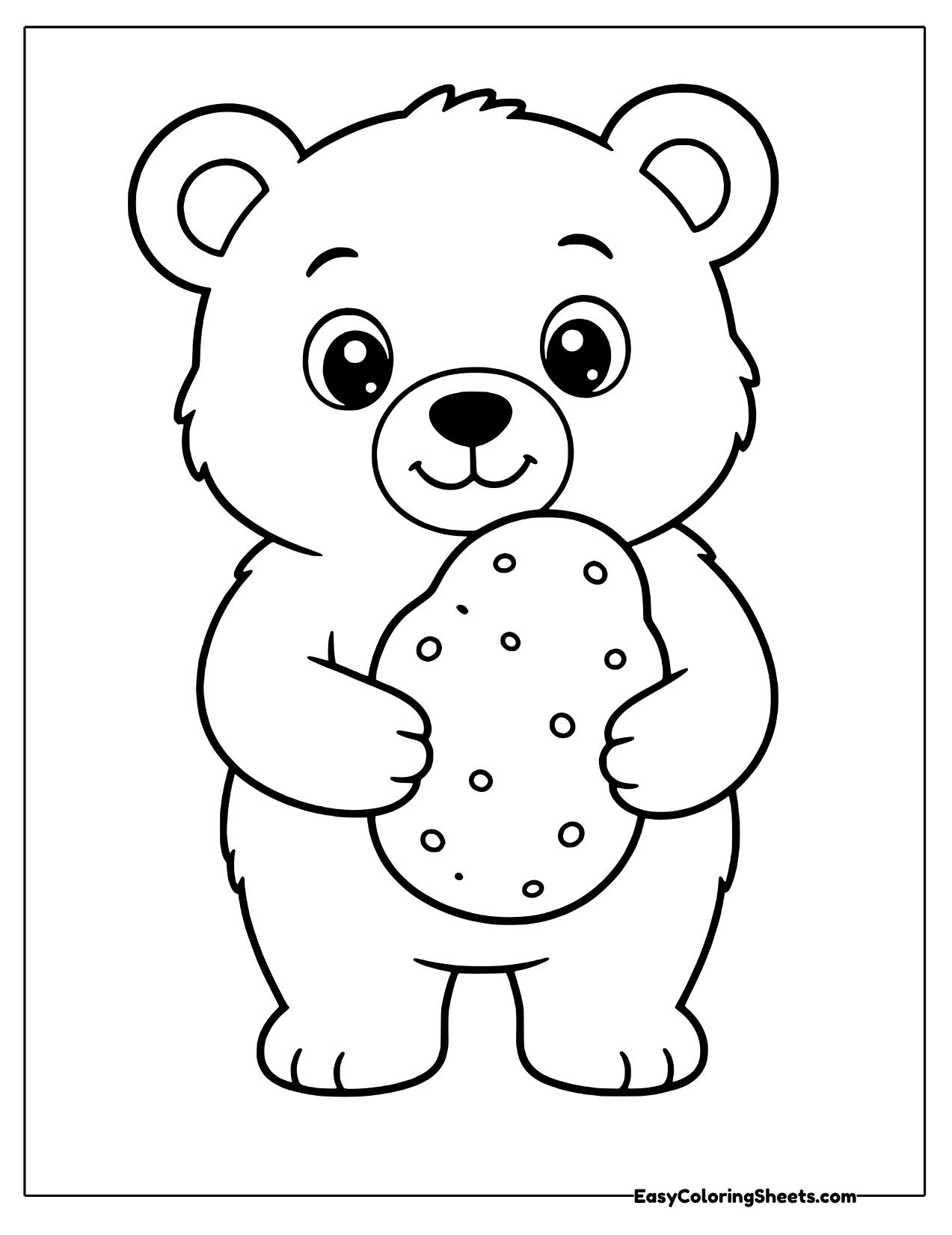 Wide eyed bear cub holding a spotted russet potato