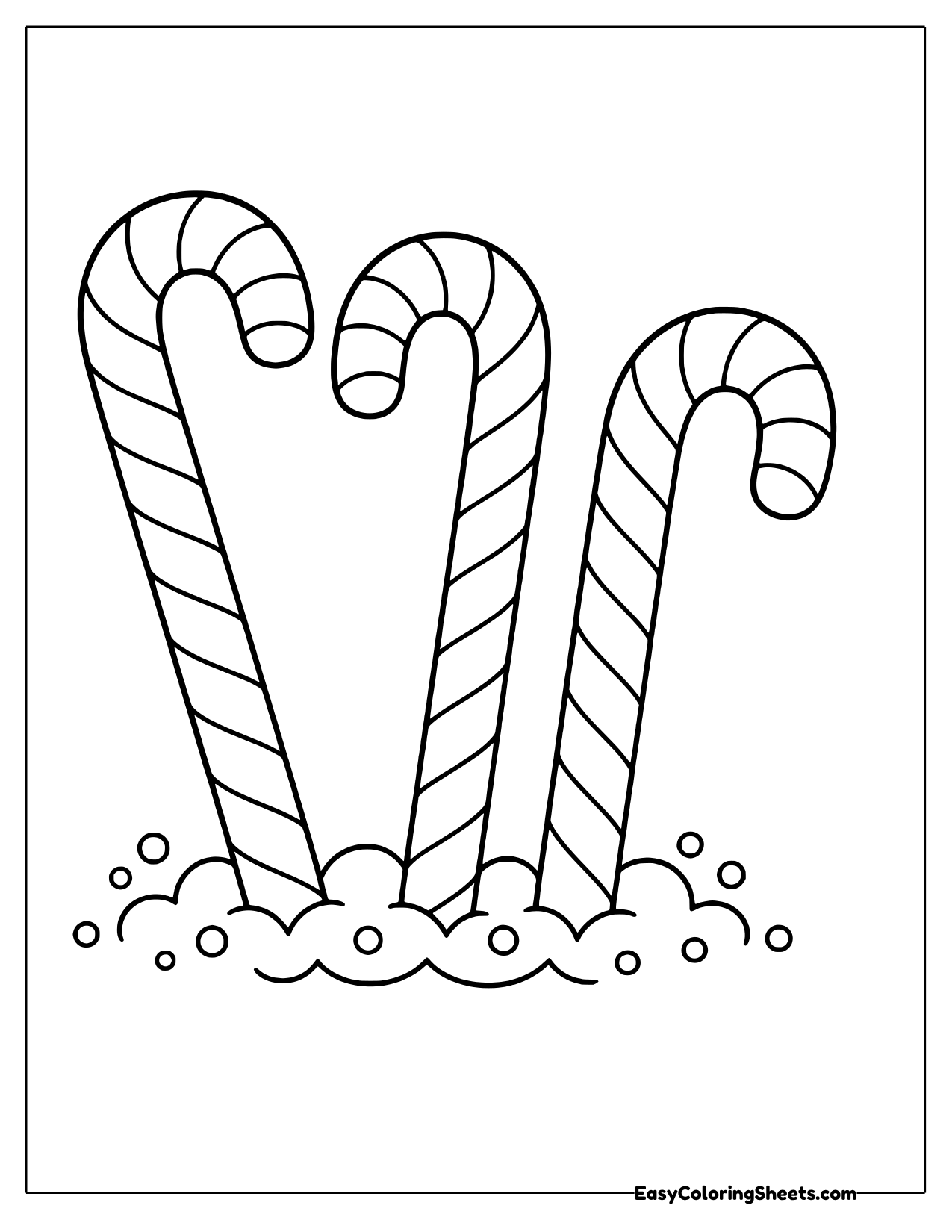 Three candy canes standing in the snow