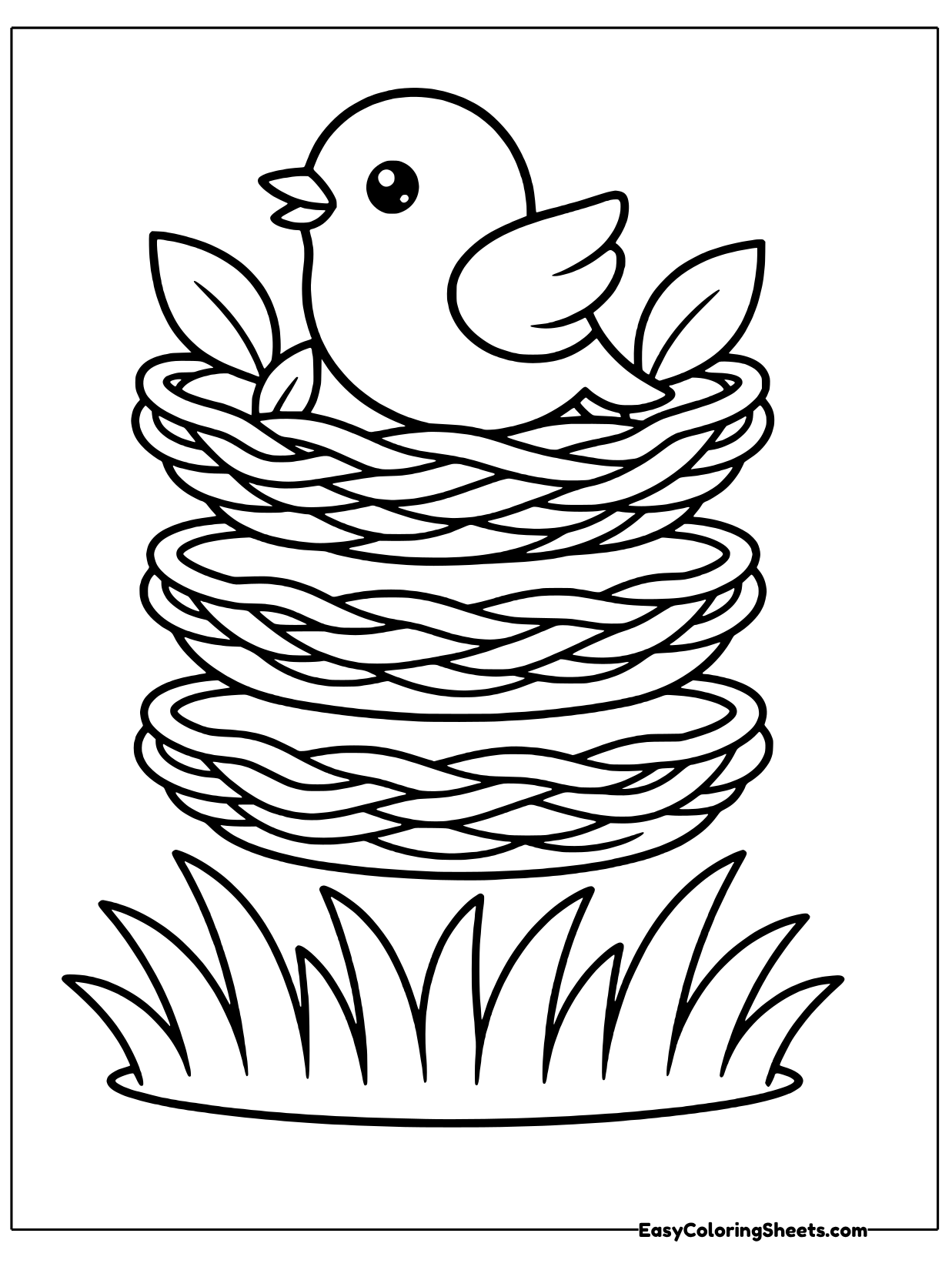 A bird sits in a large woven nest with leaves on each side and grass below.