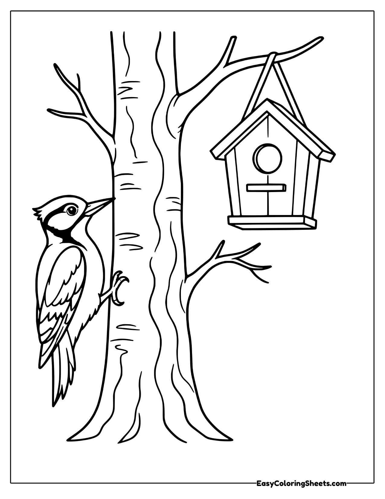 Woodpecker clinging to a tree trunk beside a hanging birdhouse