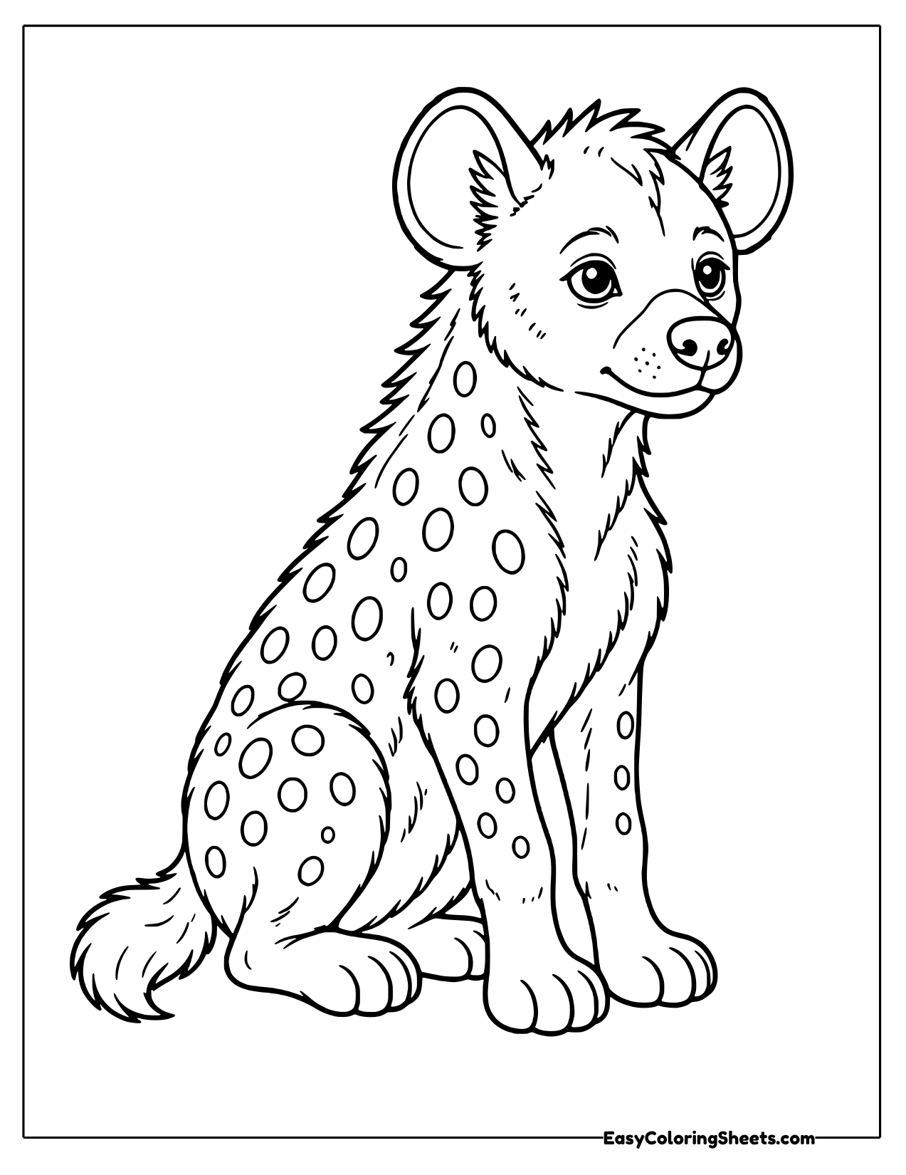 Spotted hyena cub sitting upright with round ears and a spotted coat