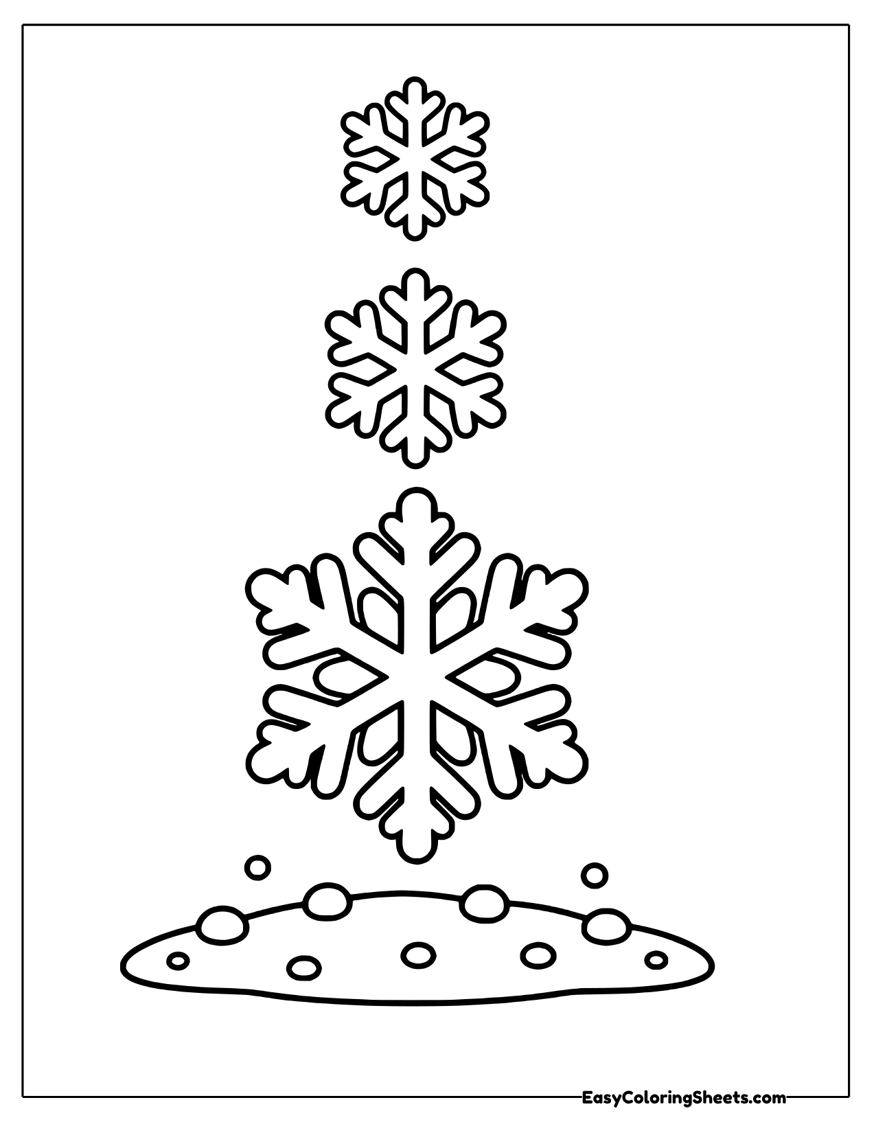 Three snowflakes stacked in a tower above snow