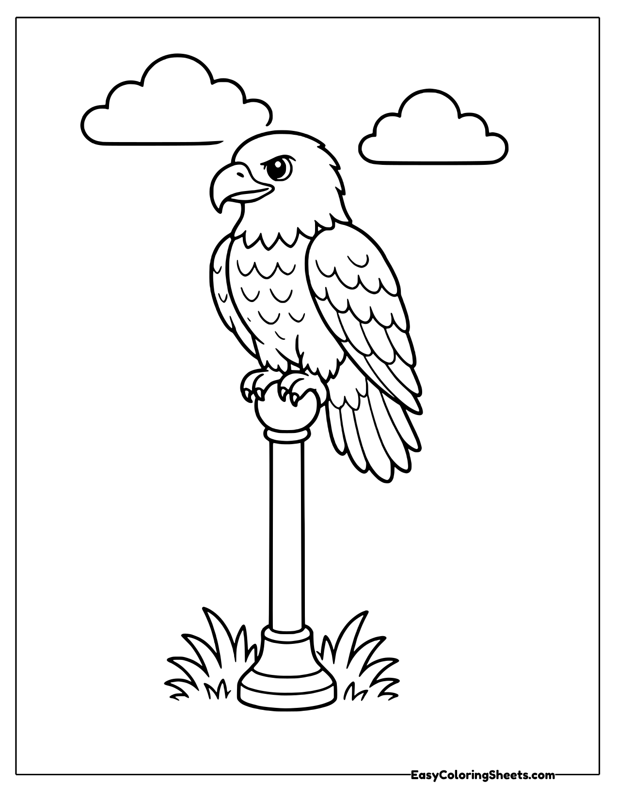 Bald eagle perched on a tall post base