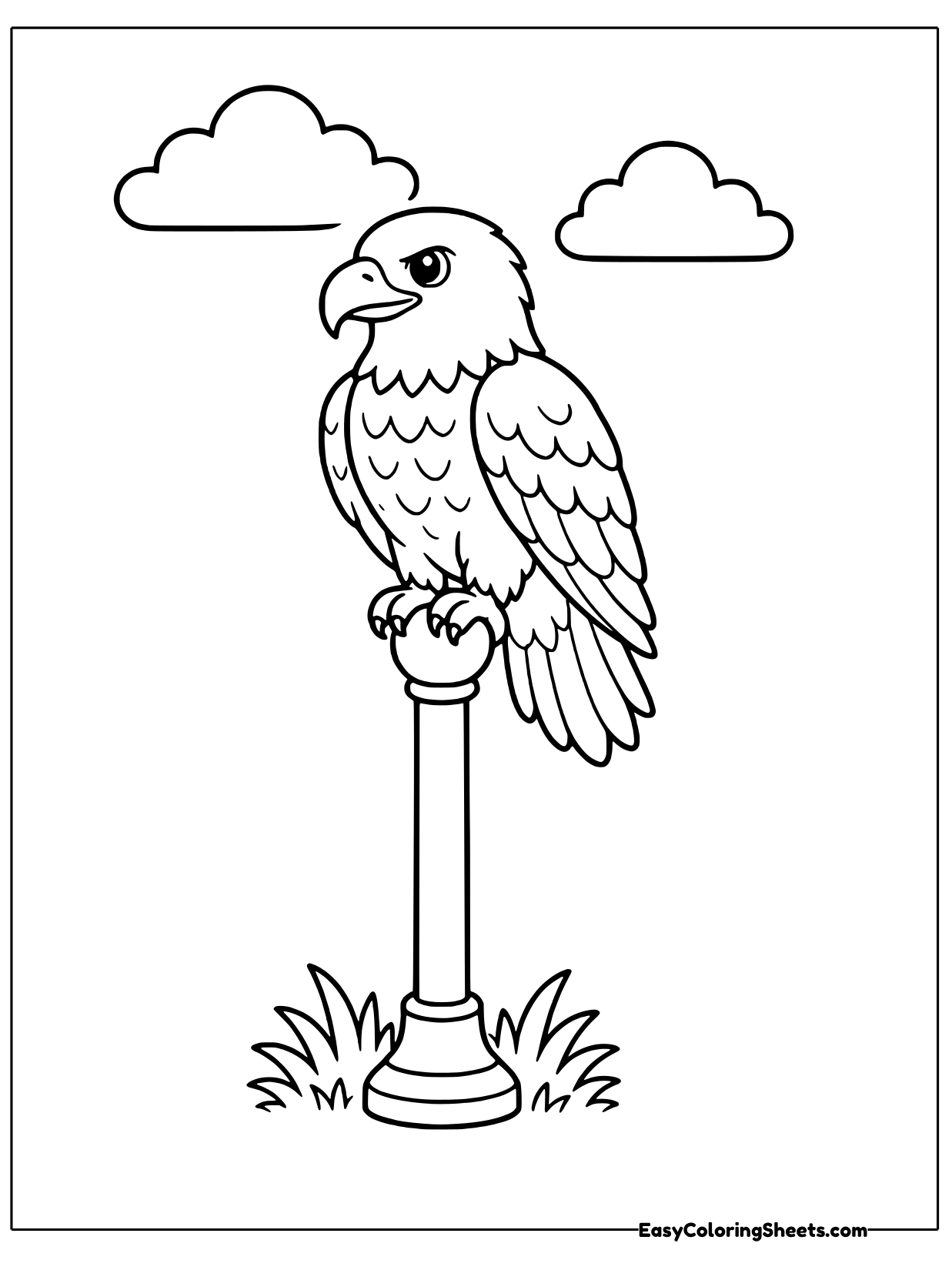 A bald eagle sits on top of a tall pole with a round base, with clouds in the sky.