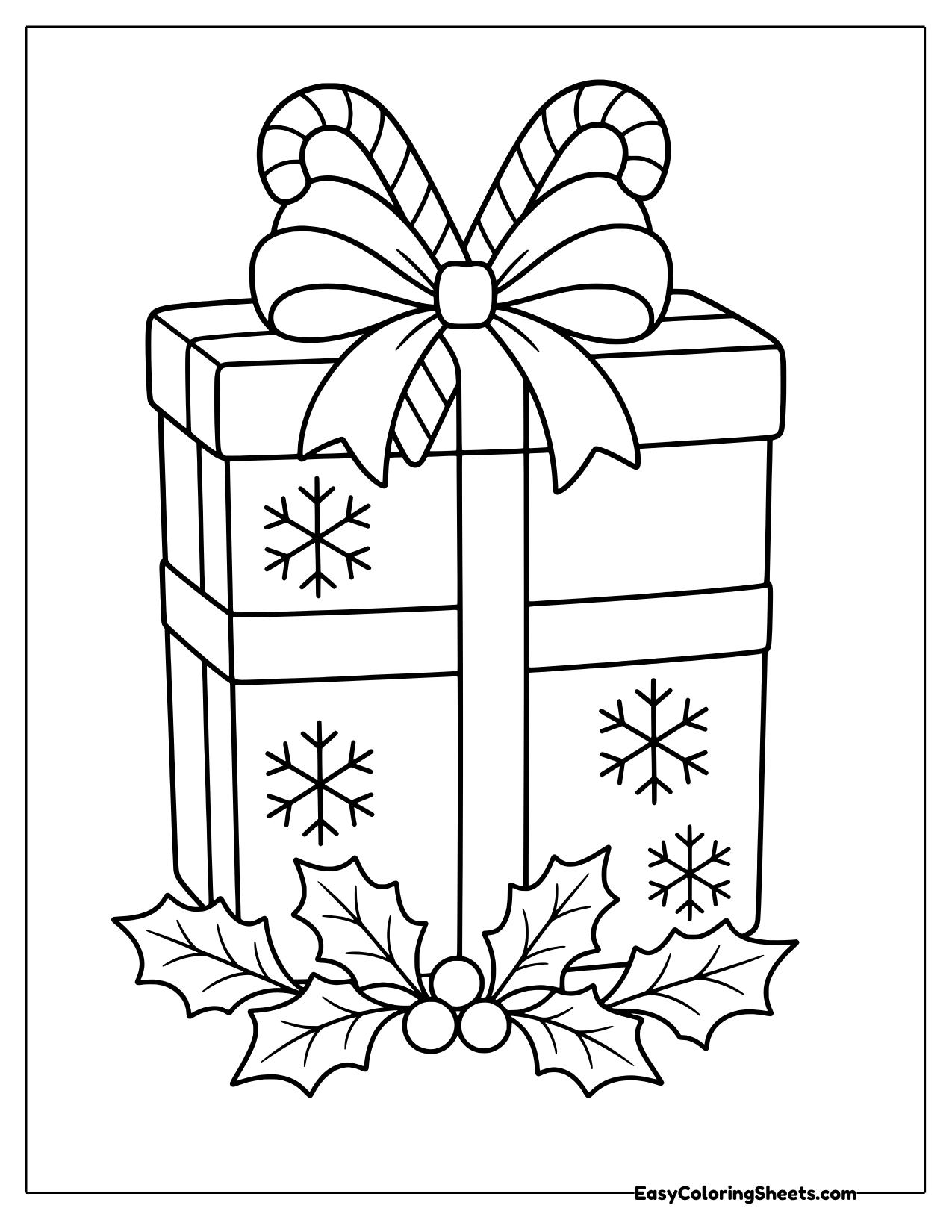 Christmas present with candy canes in the bow and holly
