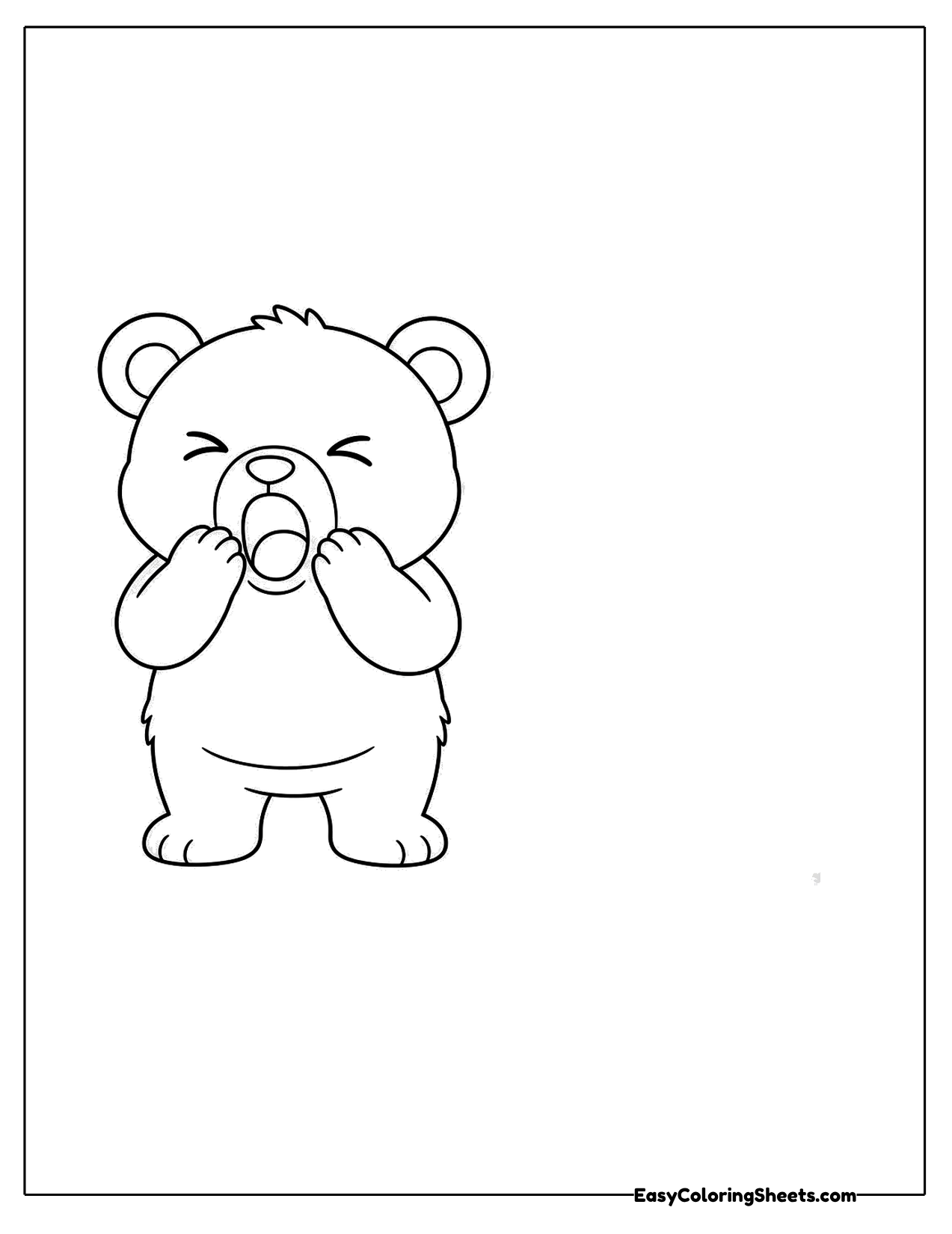 Bear cub yawning with paws on its face