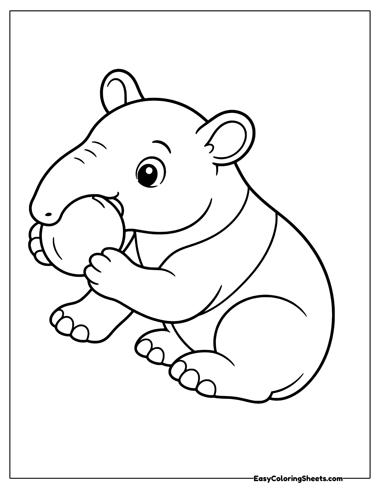 Tapir munching on a piece of fruit