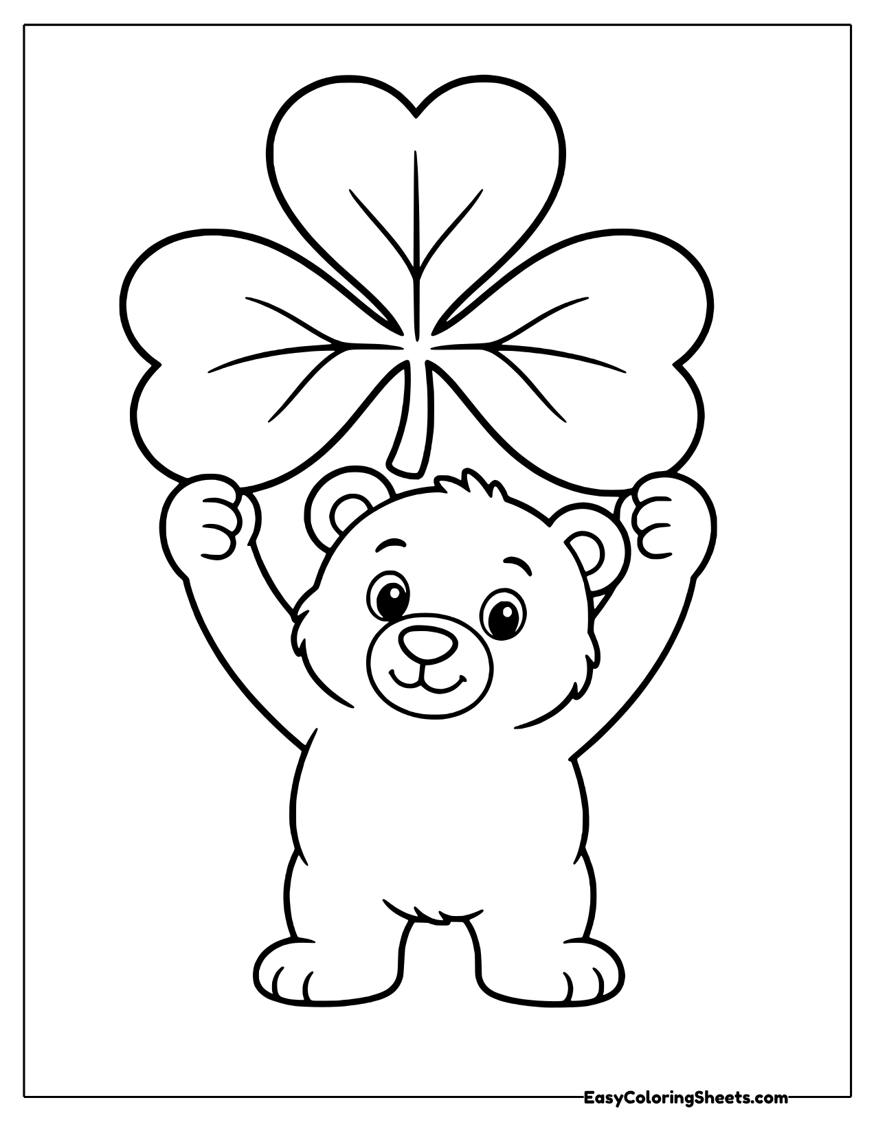 Cheerful bear cub holding a giant three leaf shamrock overhead