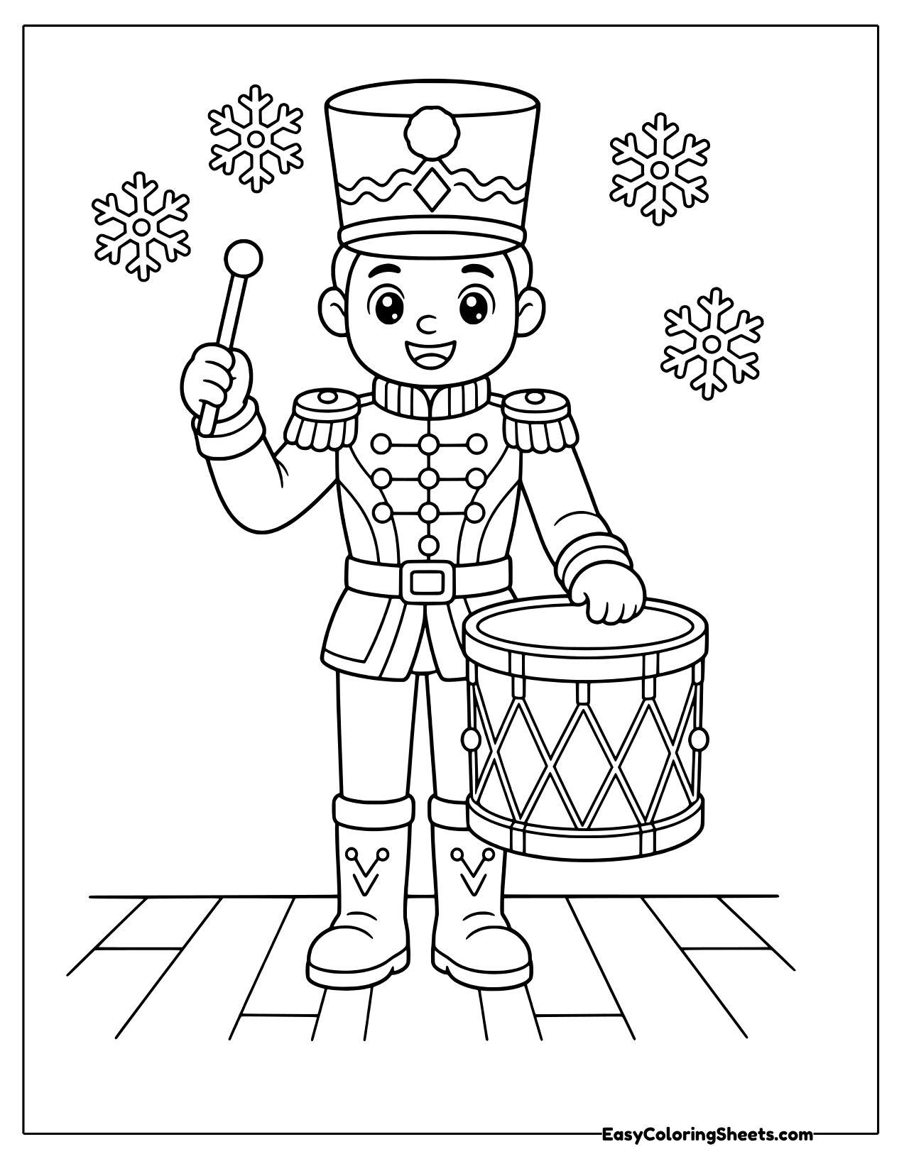 Nutcracker drummer standing beside a big drum with a drumstick raised