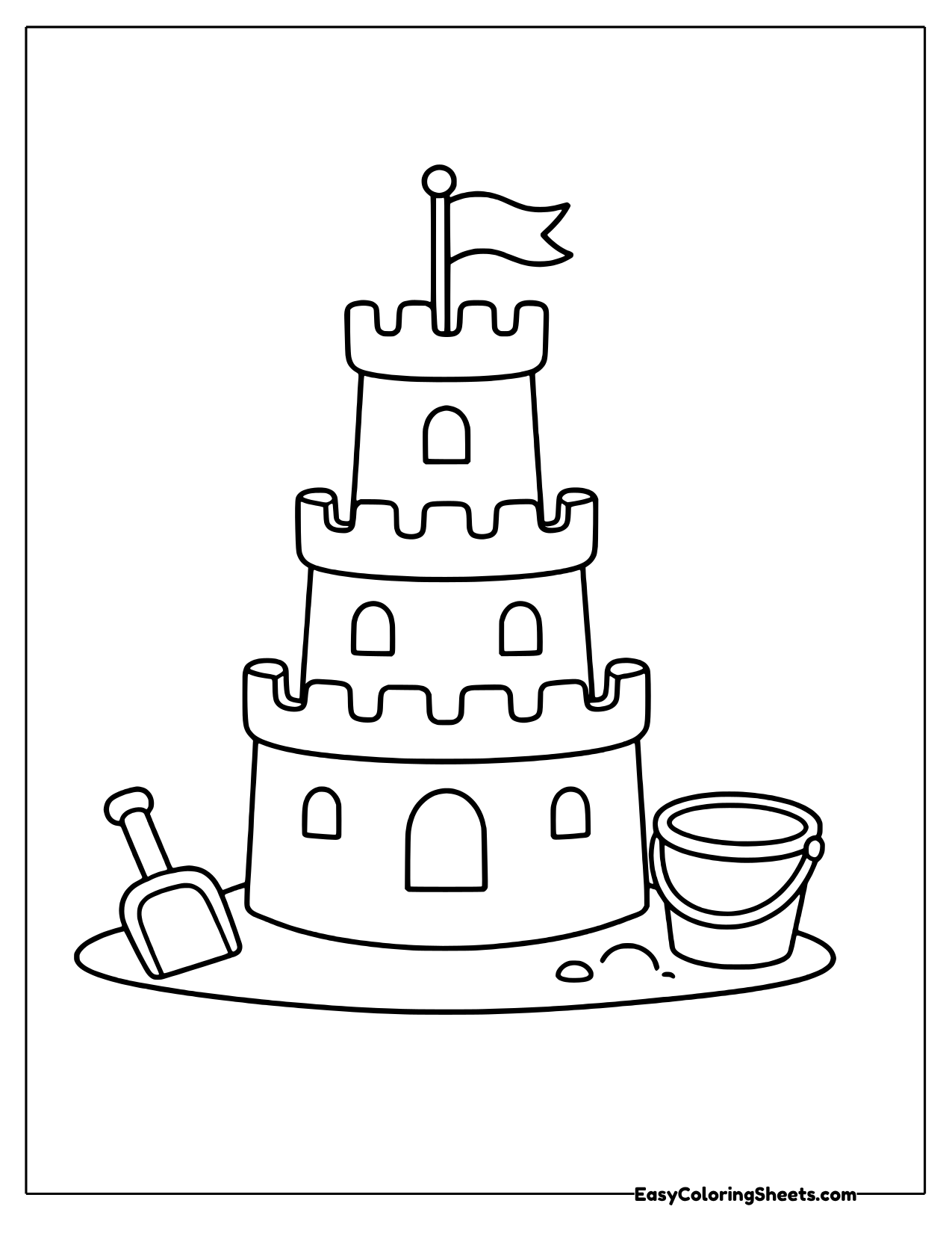 Sandcastle with a flag, shovel and bucket