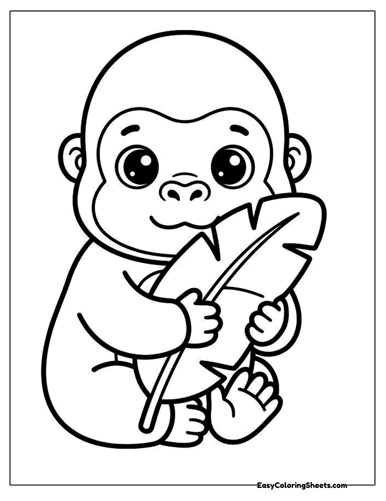 Cute young gorilla holding a big leaf