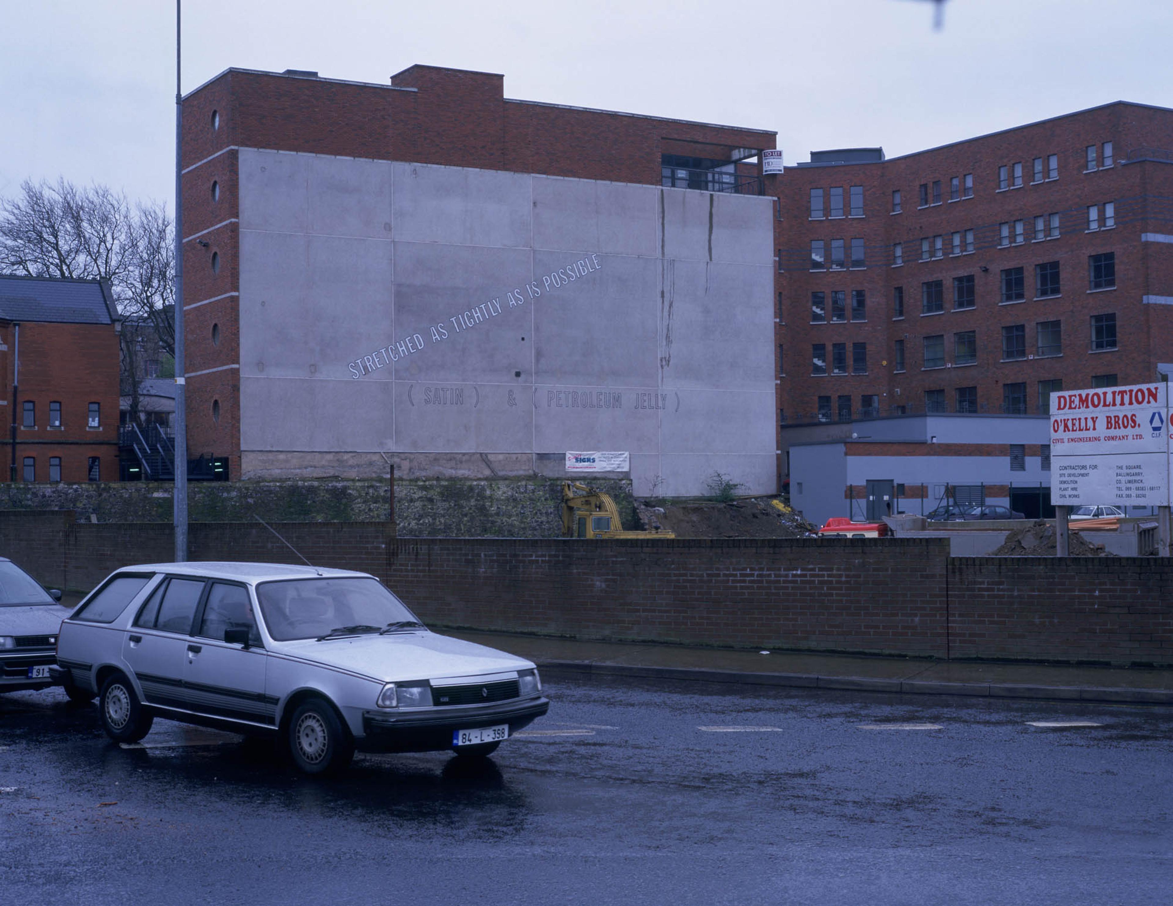 (1996) Install shot, Lawrence Weiner, Stretched as Tightly as Possible, text on wall.