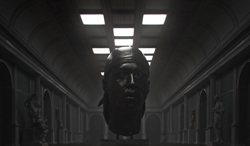 A Bronze bust of artist Pa Salieu sits centrally within a museum along with other classical sculptures from the neoclassical period.