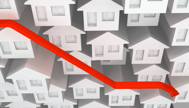 An illustration of white model houses with a red line falling steeply across them.