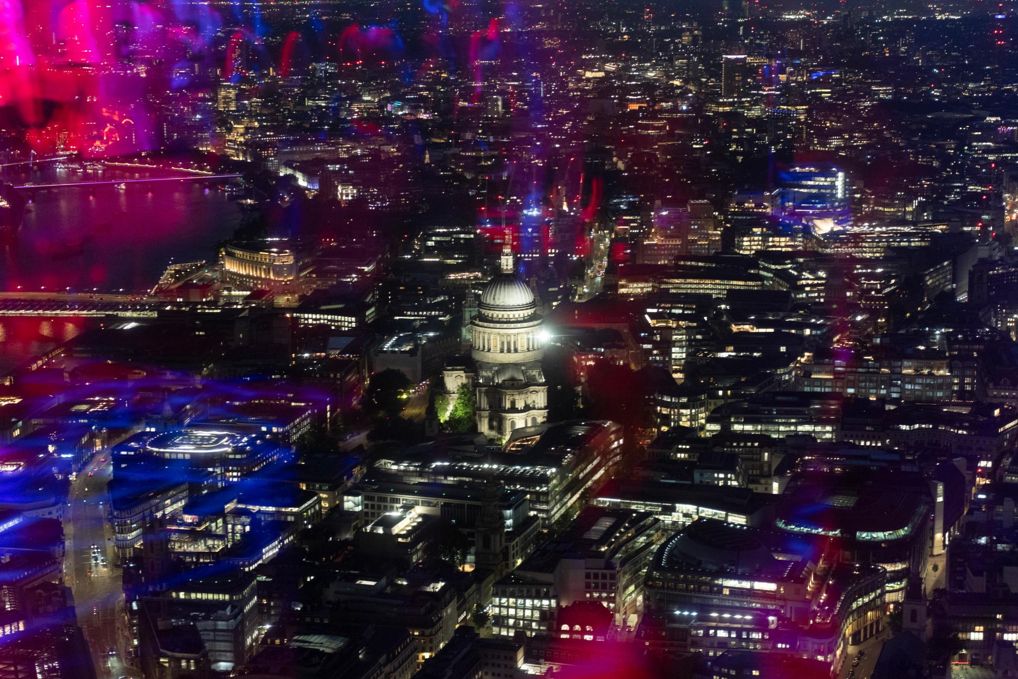 View over St Pauls Cathedral at night with pink lights on reflection