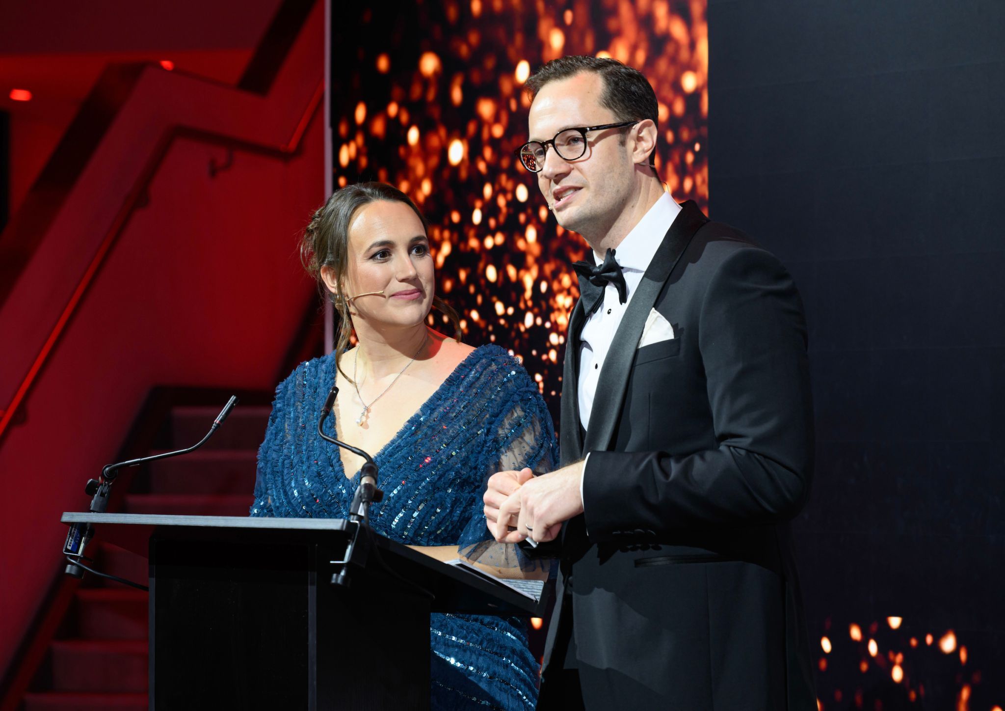 Man and woman at podium