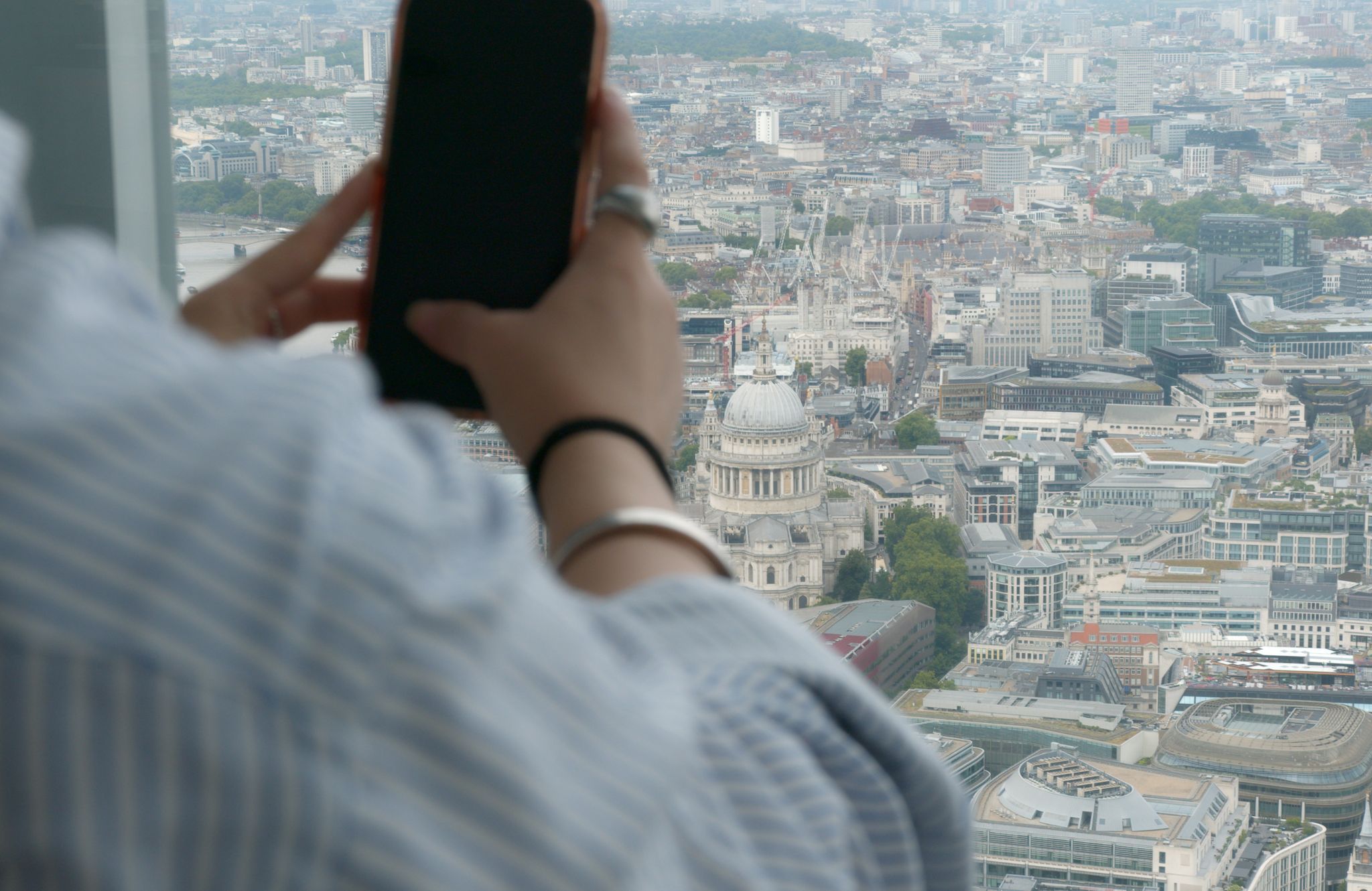 Lady using phone at the window