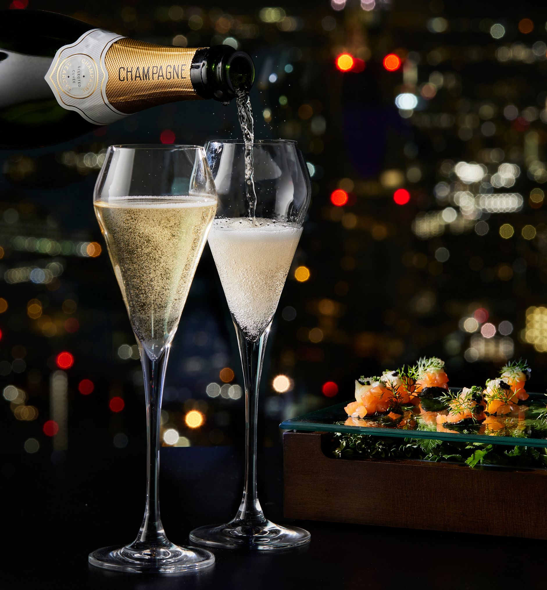 Bottle filling champagne glasses