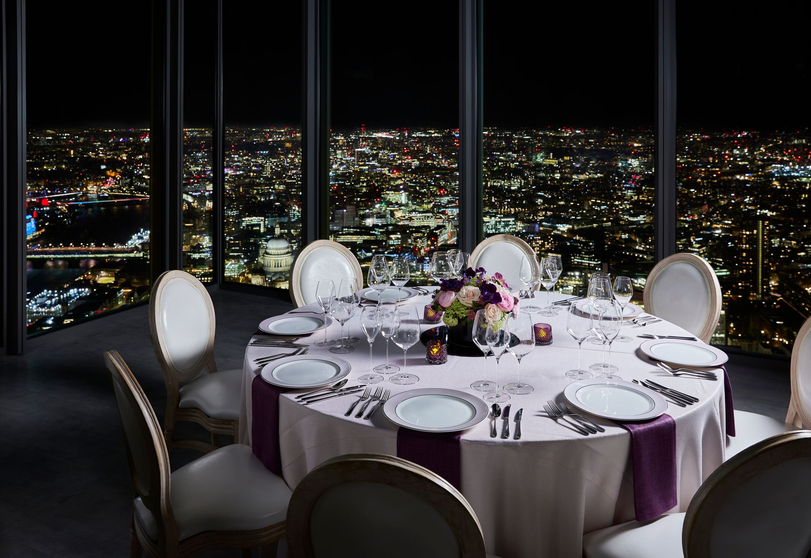 Table set for dinner with London skyline in background