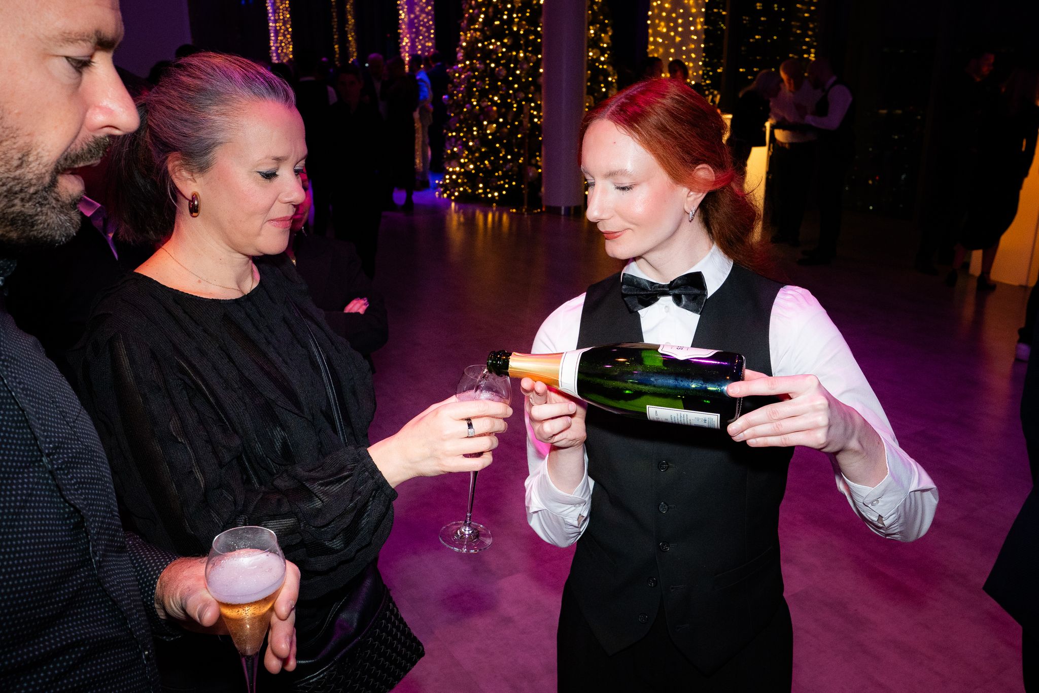 A waitress pouring champagne