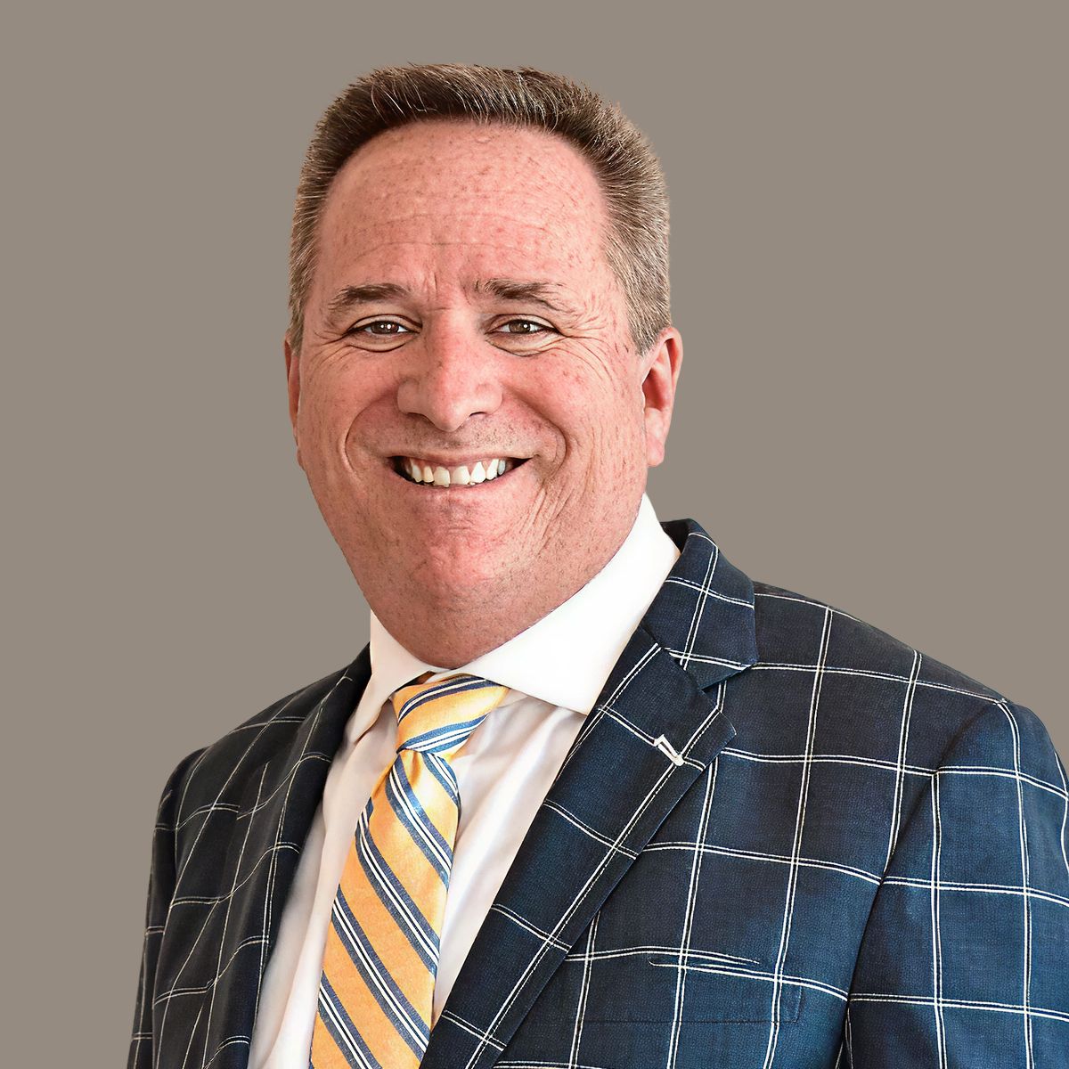 Attorney portrait - male lawyer in plaid blazer and tie, professional headshot