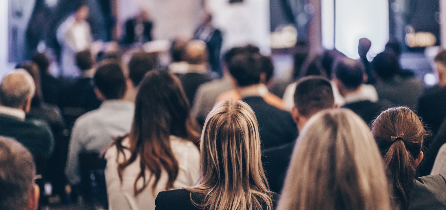audience looking at a presenter in an event space
