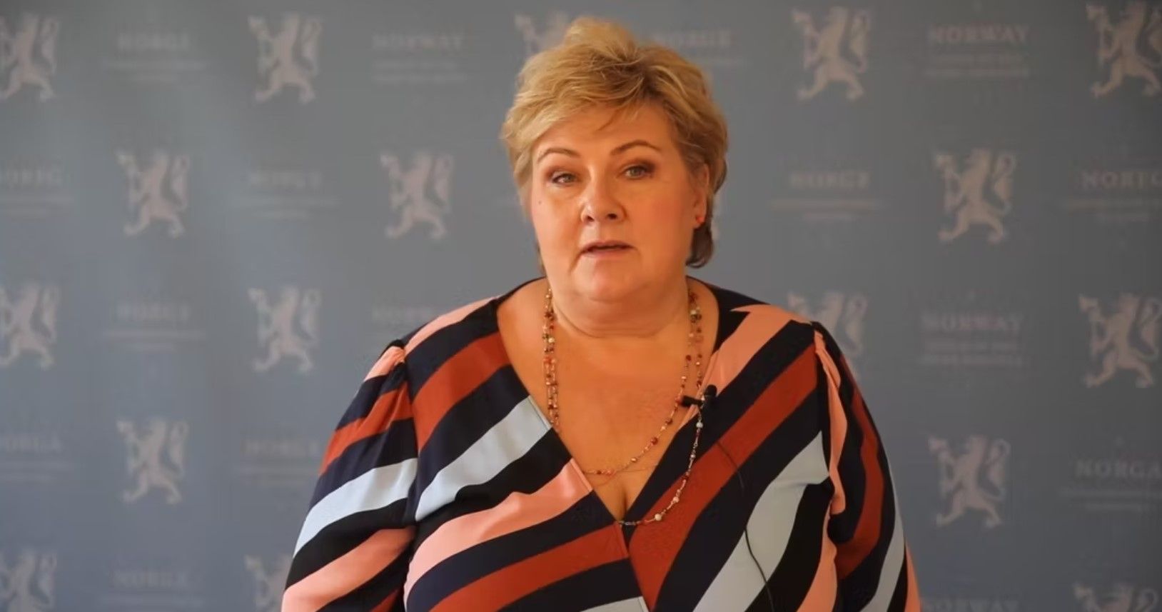 Women in a striped dress speaking