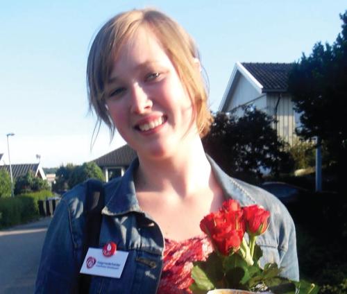 Portrait of a smiling young person with red roses.