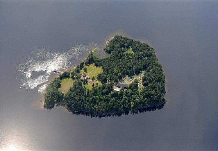 Color photo with areal view of island surrounded by water. 