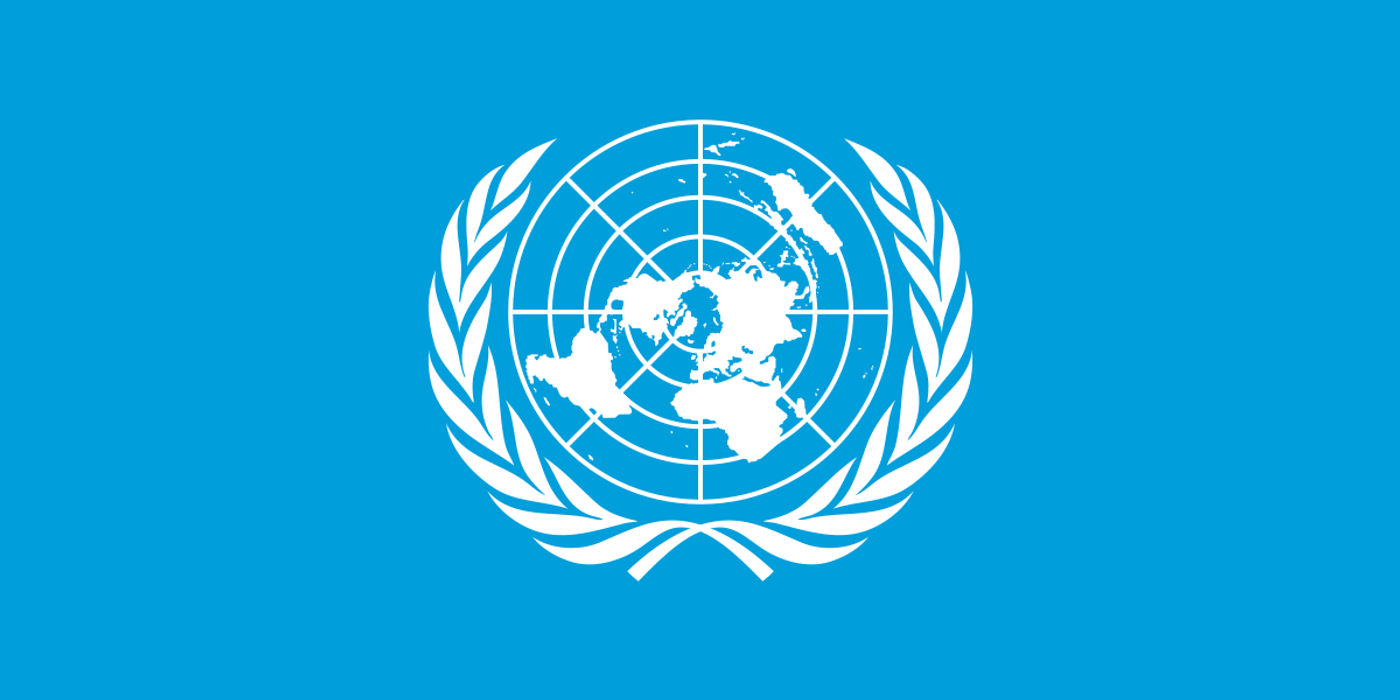 Blue background. White badge with wreath and world map.