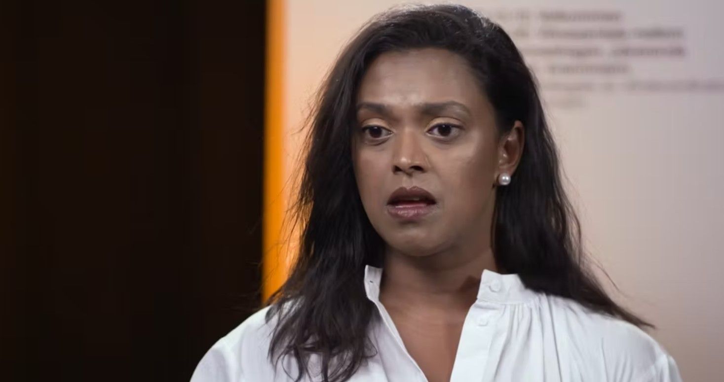 Woman in white shirt talking. Blurred background