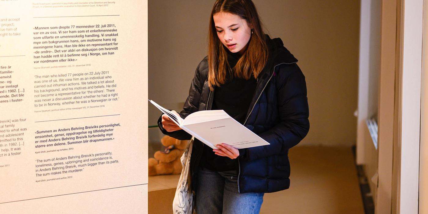 A person reads a book in the exhibition. An exhibition item
