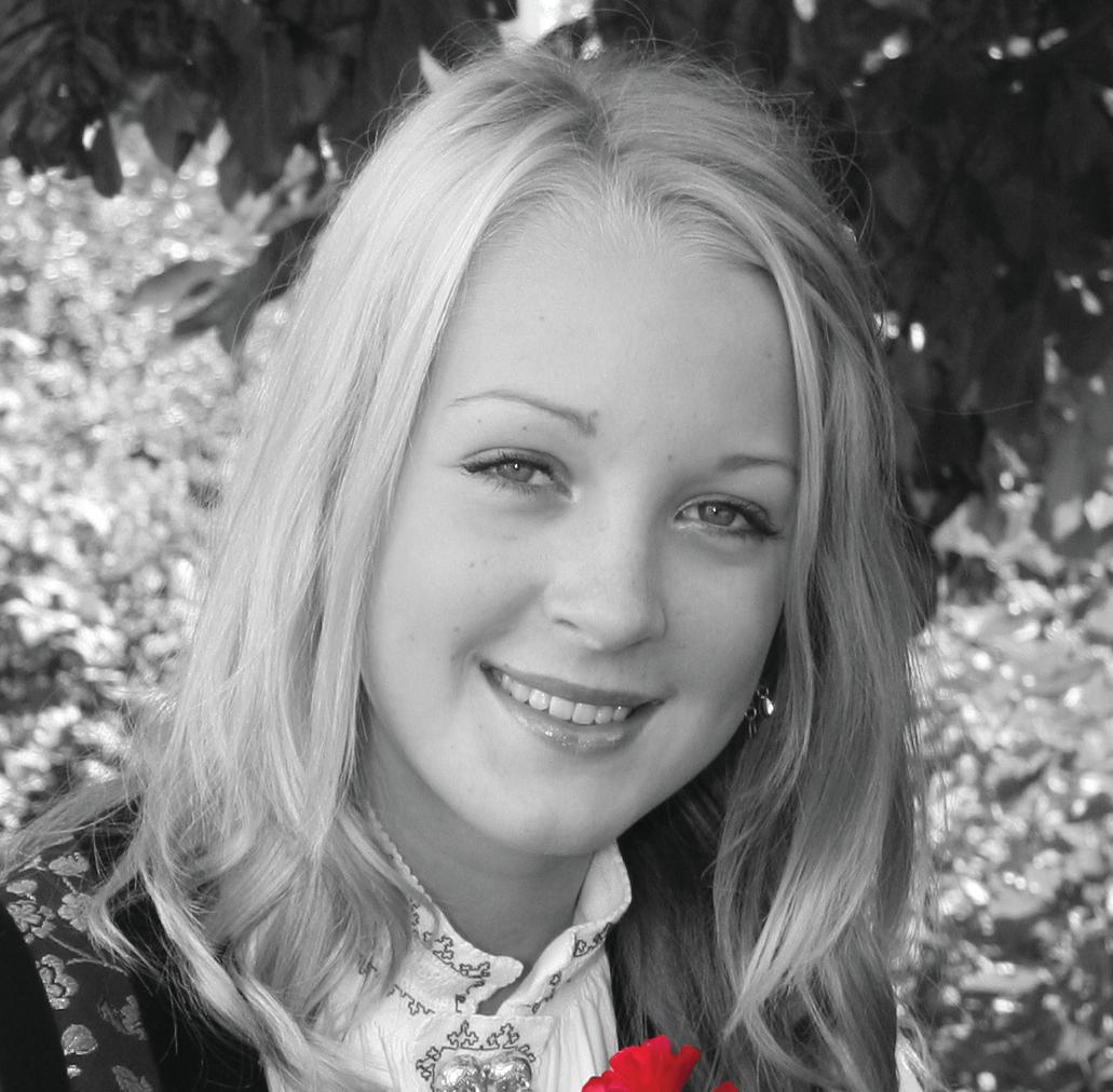 Portrait of a young girl with a rose, wearing a norwegian traditional custom. The photo is black and white, but the rose is red.