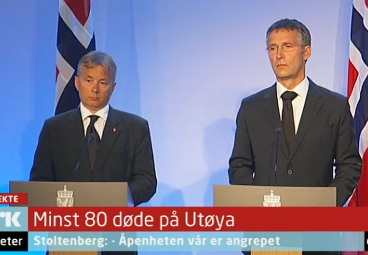 Two men in suits. Two large Norwegian flags behind. Text NRK, news. Large text At least 80 died on Utøya, smaller print Stoltenberg: Our openness is under attack. The clock shows 08:22.