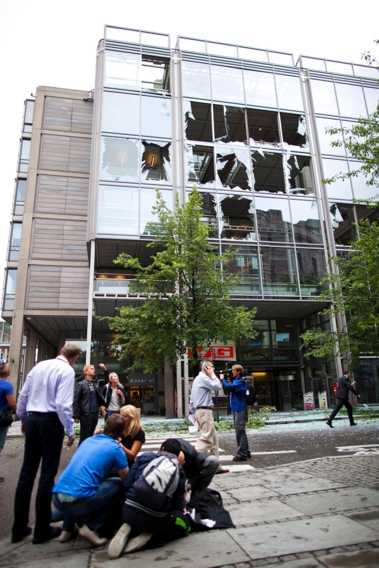 Five people ahead. stone floor. Six people in the background. Damaged building with broken glass in the background