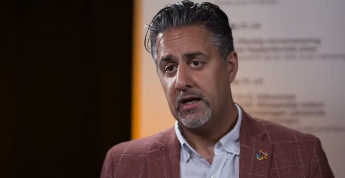 Man in suit speaking. Blury background