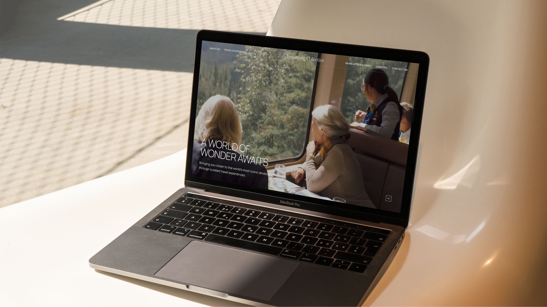 Armstrong Collective homepage on a laptop computer