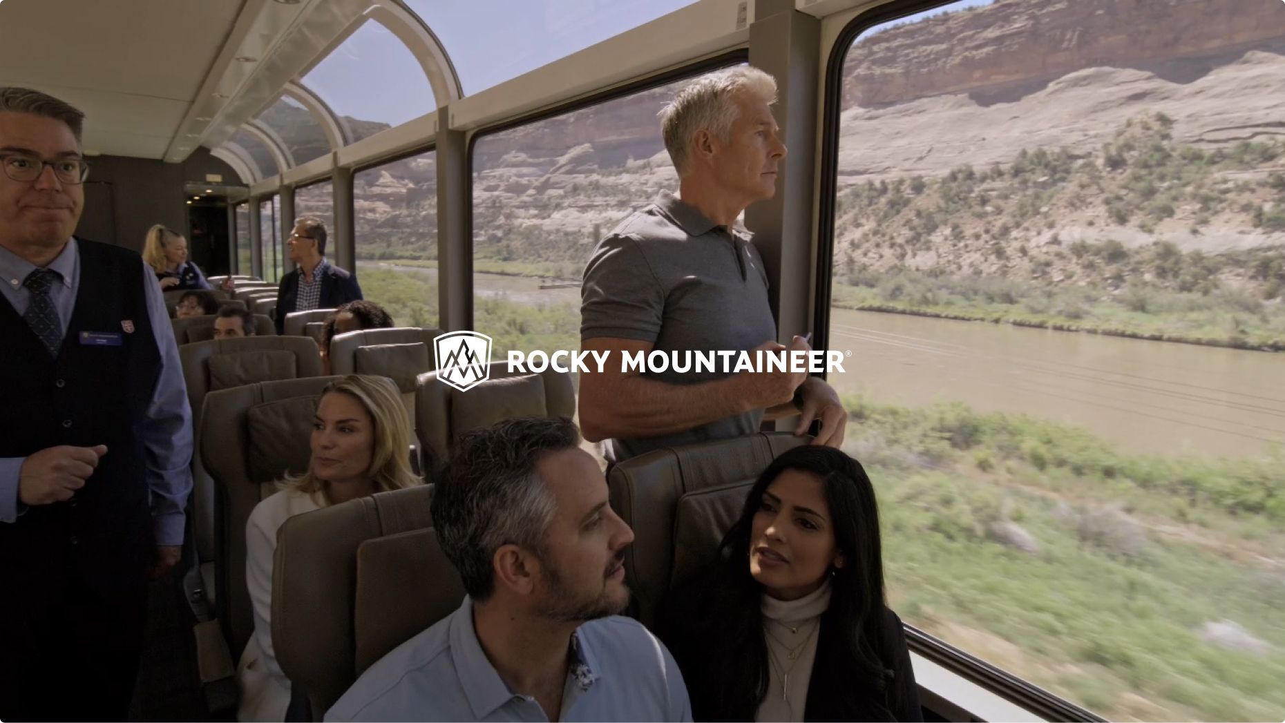 Guests enjoy the view from a Rocky Mountaineer train