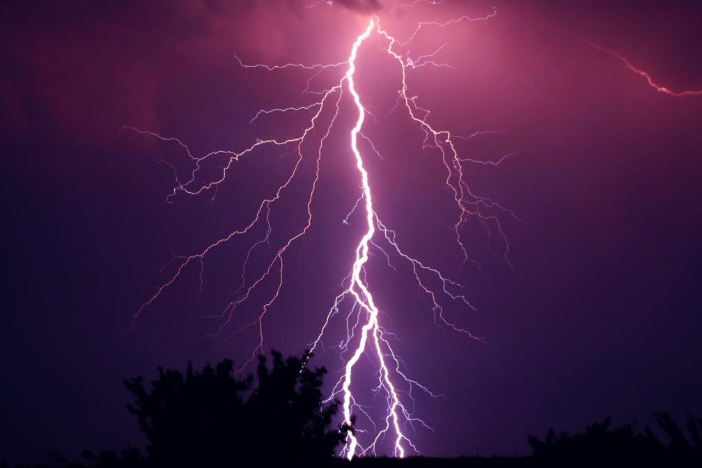 Lightning bolt striking ground at night