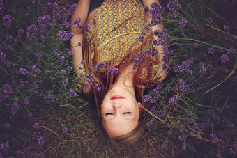 Girl smiling in a field of purple flowers