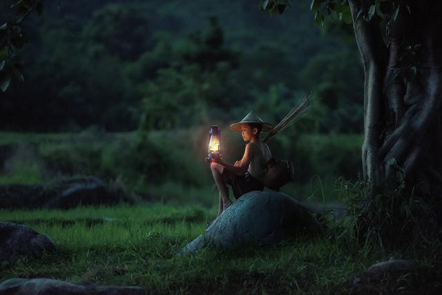 Boy in night with lantern