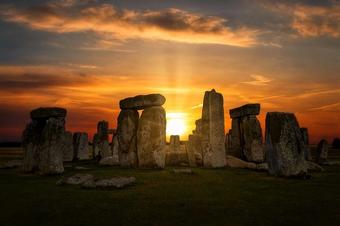 Sun peaking through hole in rocks Stonehenge