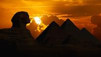 Sphinx and pyramids against sunset